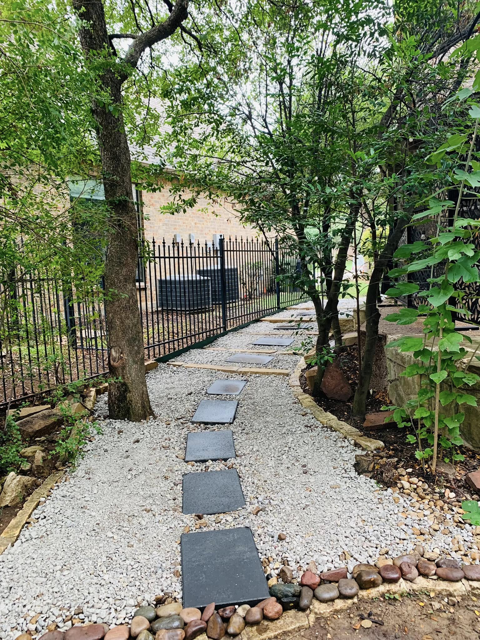 Completed stone walkway through a landscaped side yard